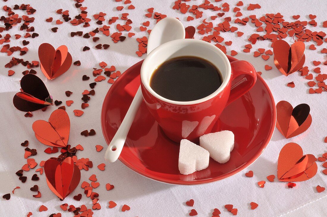A cup of espresso with heart-shaped sugar lumps