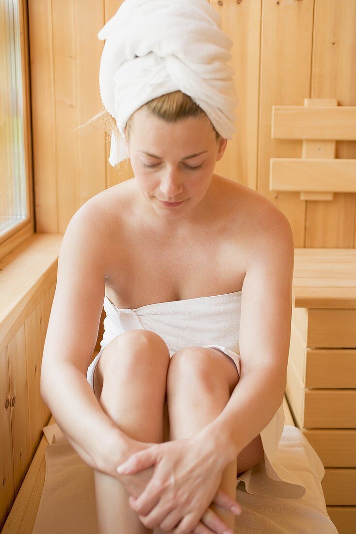 Woman sitting in a sauna