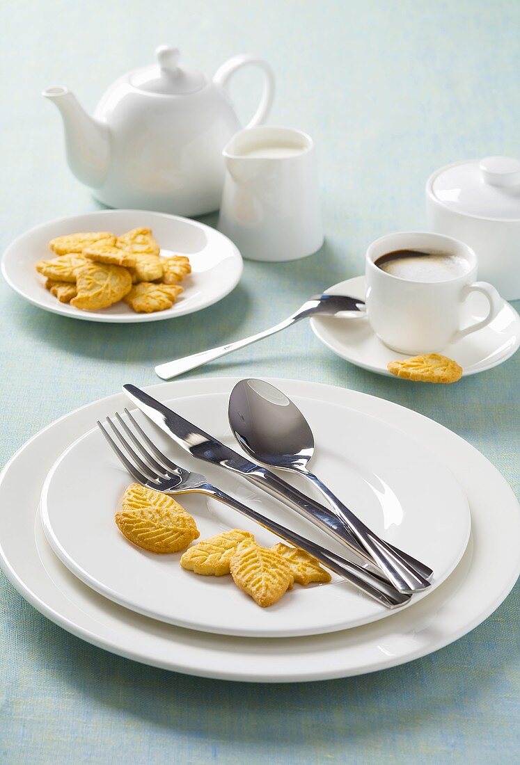 White place-setting with biscuits and coffee