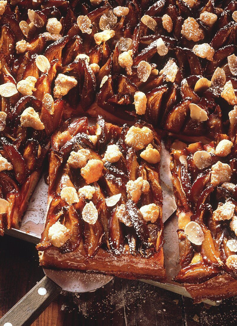 A tray of plum cake with crumble topping