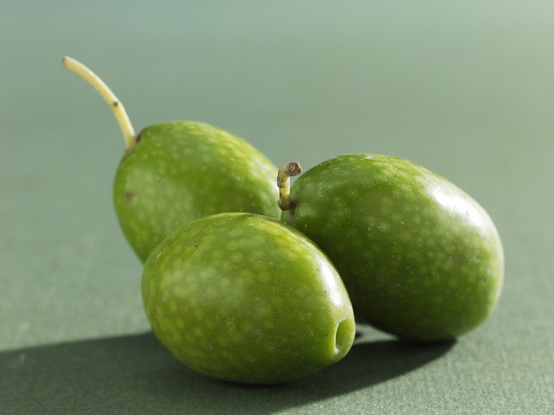 Three green olives (close-up)