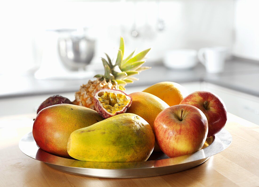 Dish of fruit (apple, pineapple, papaya, mango, passion fruit)