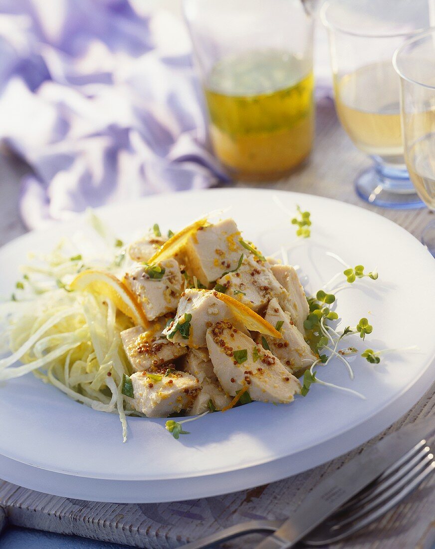 Chicken with mustard seeds and orange slices