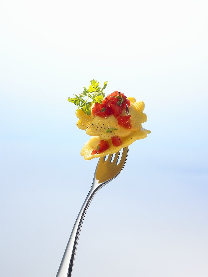 Two agnolotti (filled pasta) on a fork