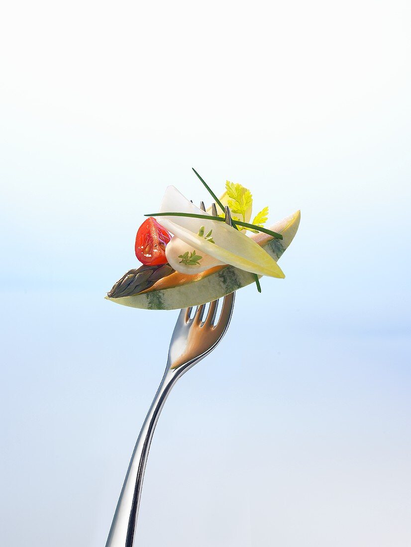 Melon, asparagus and salad on a fork