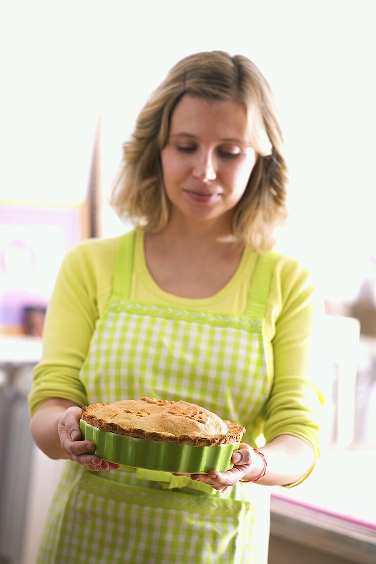 Woman holding an apple pie