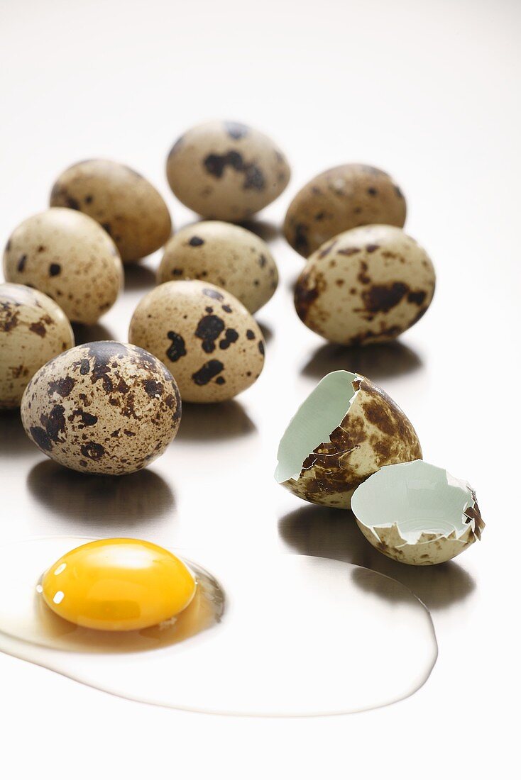 Several quails' eggs, one broken