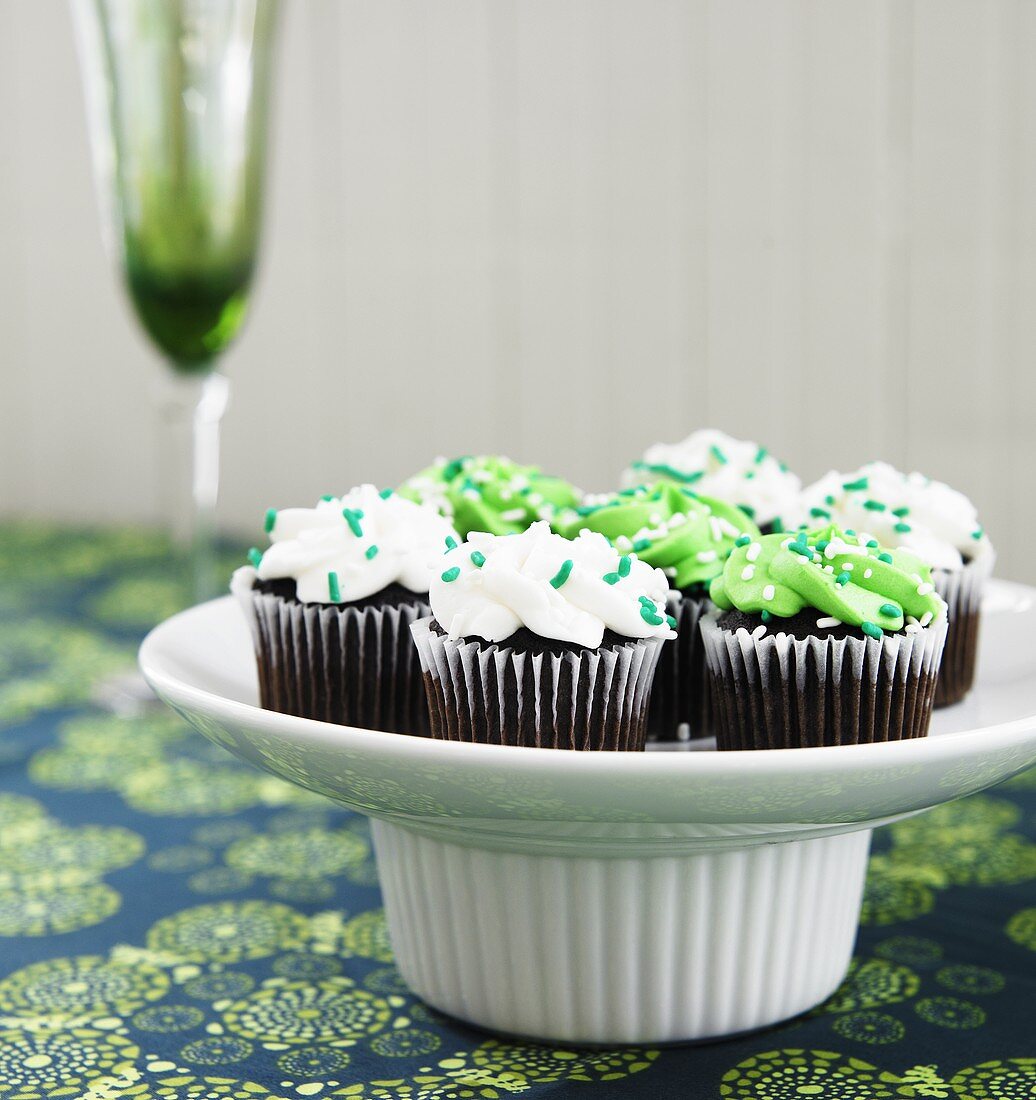Mini Chocolate Cupcakes with Vanilla and Green Frosting; Green Sprinkles