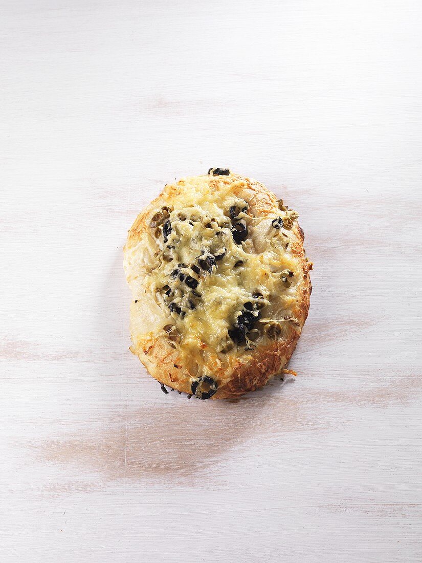 Fougasse topped with cheese and olives