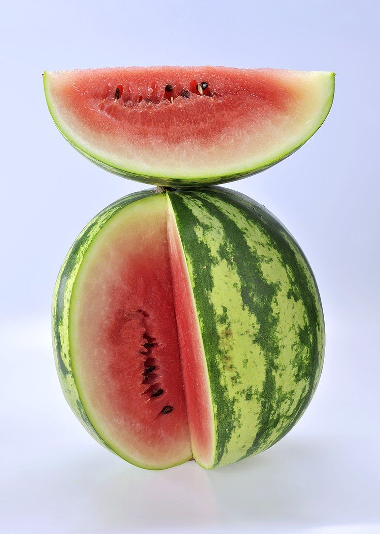 A slice of watermelon on top of a sliced watermelon