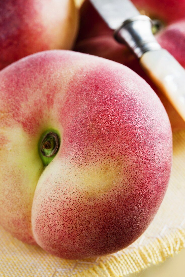 A peach and a knife (close up)