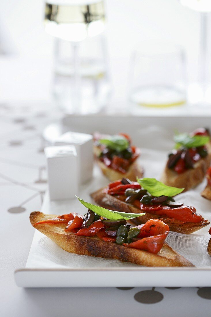 Bruschetta with pepper, capers and basil