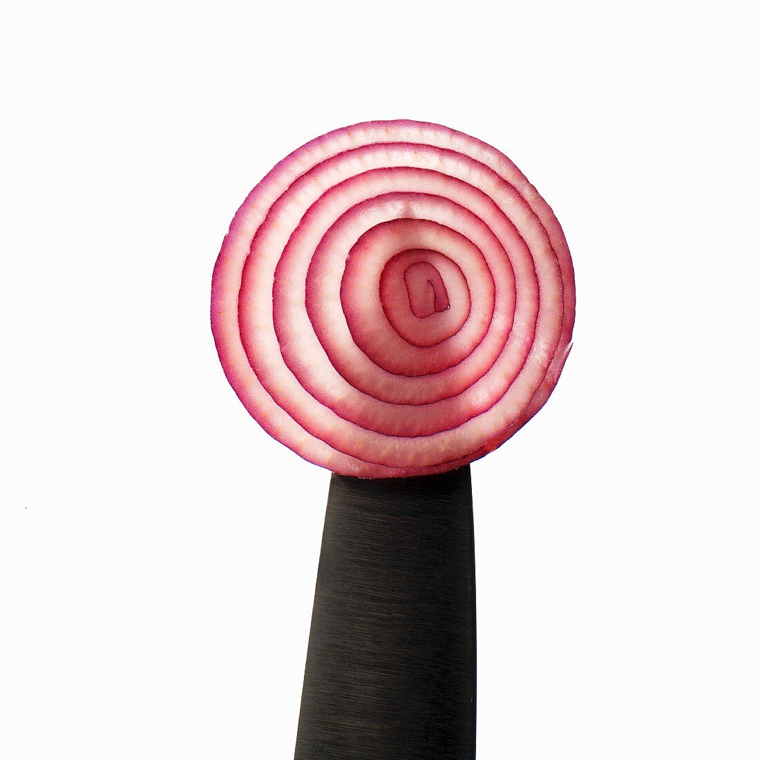 A slice of red onion on a knife