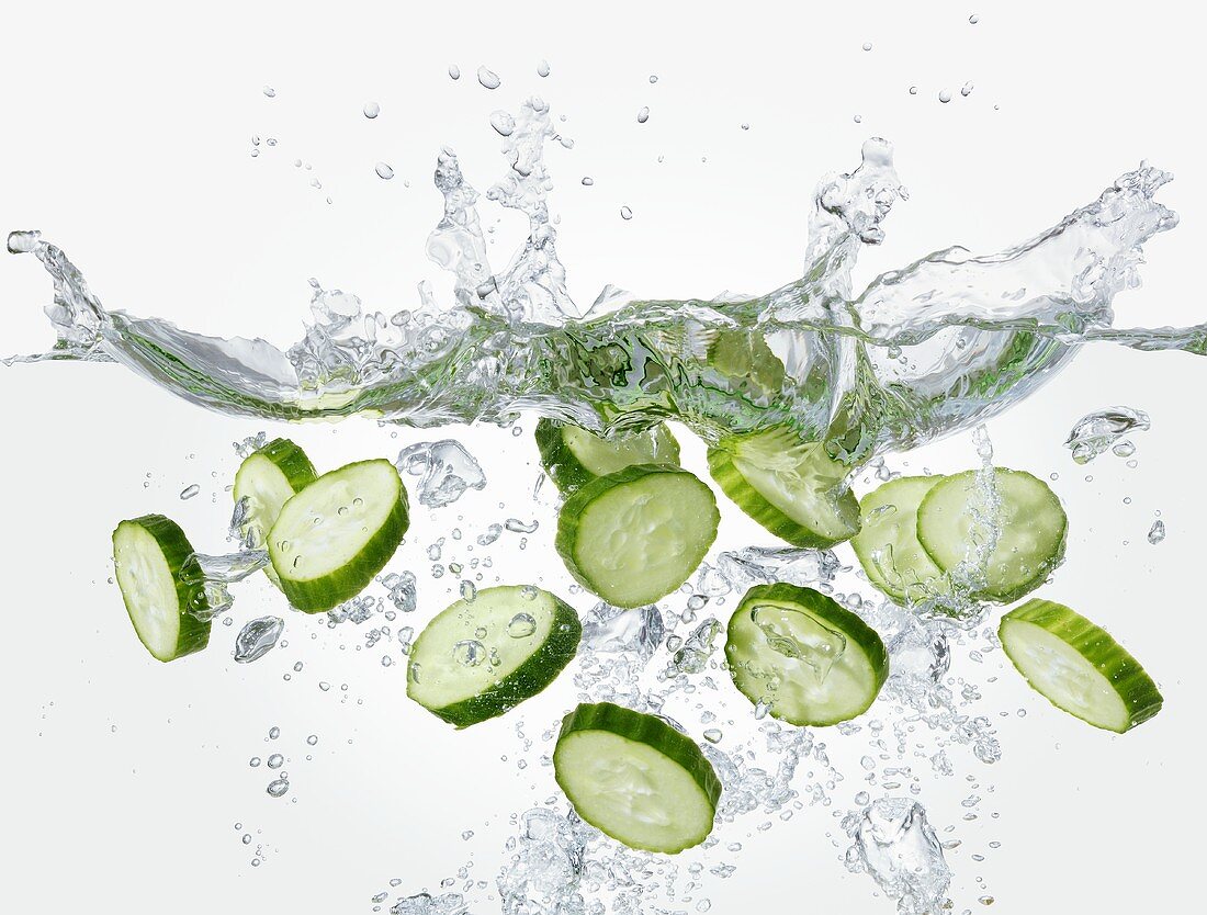 Slices of cucumber falling into water