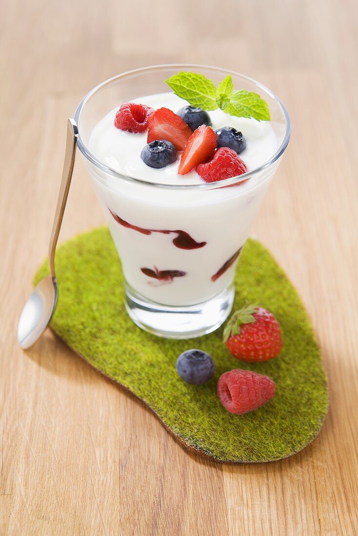 Yogurt with various berries in a glass