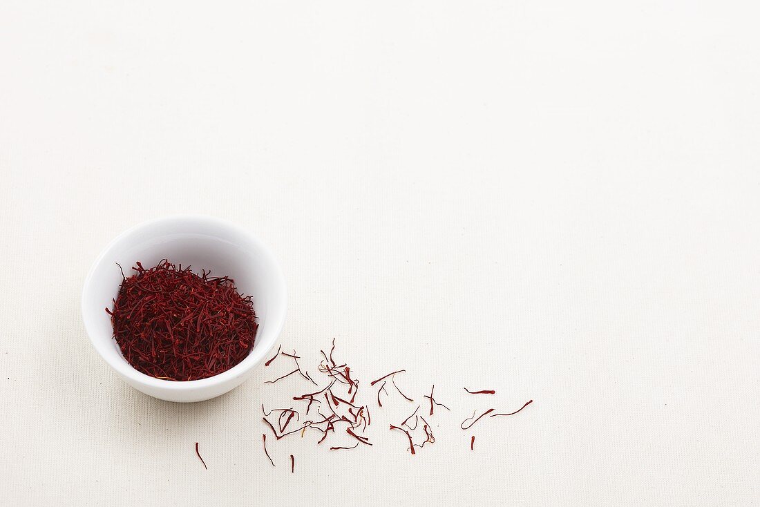 Saffron threads in a bowl and next to it