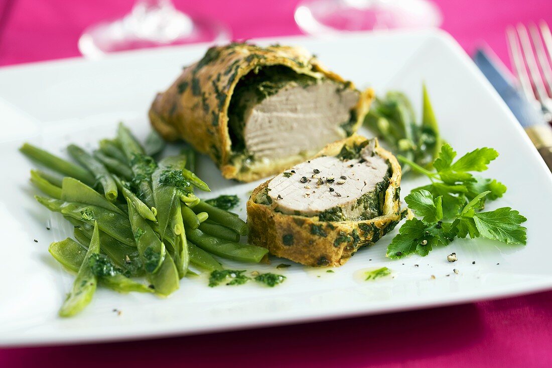 A pastry-wrapped pork fillet with herbs and mangetout