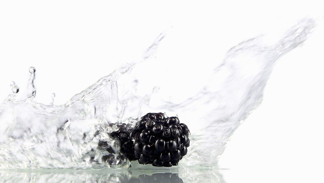 Two blackberries being washed