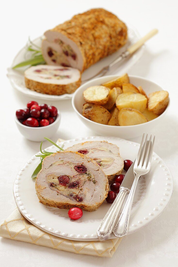 Pork roulade with mushrooms, cranberries and roast potatoes