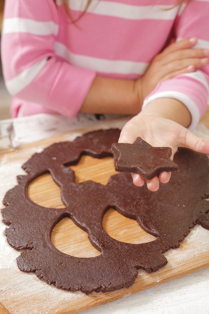 Mädchen hält ausgestochenes Sternplätzchen