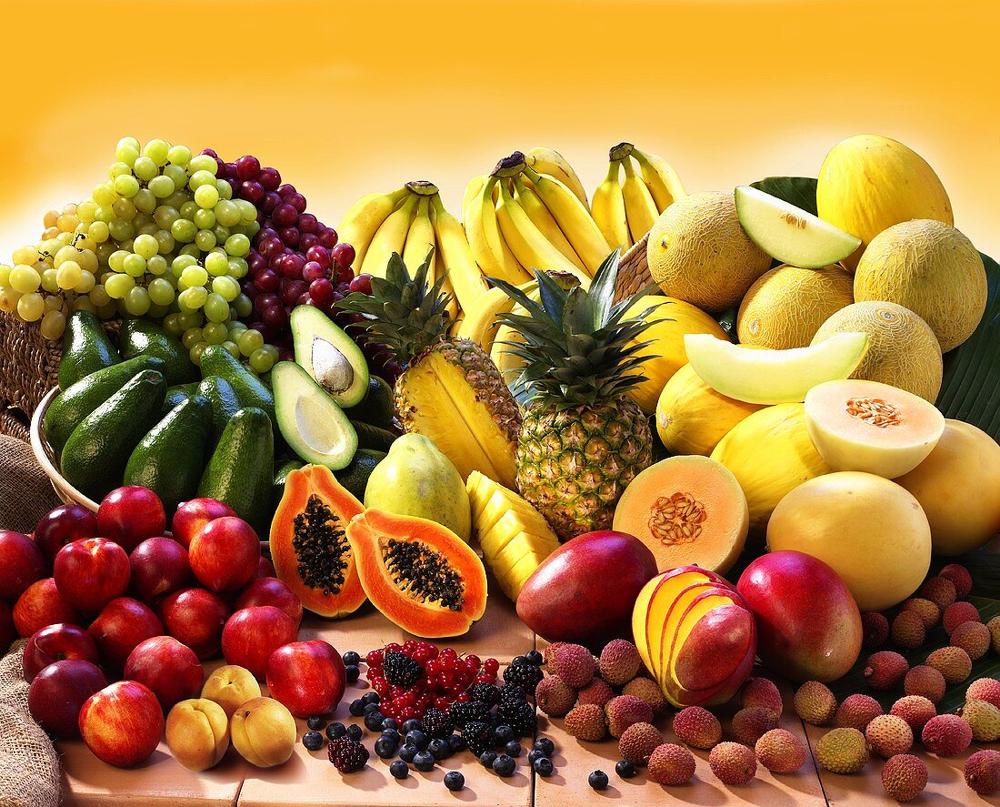 Display of exotic fruit with stone fruits, berries and avocados