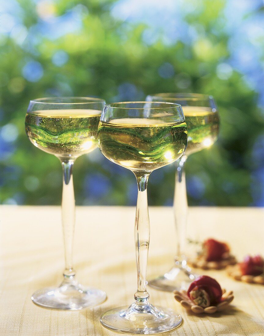 White Wine in Tall Glasses on Outdoor Table