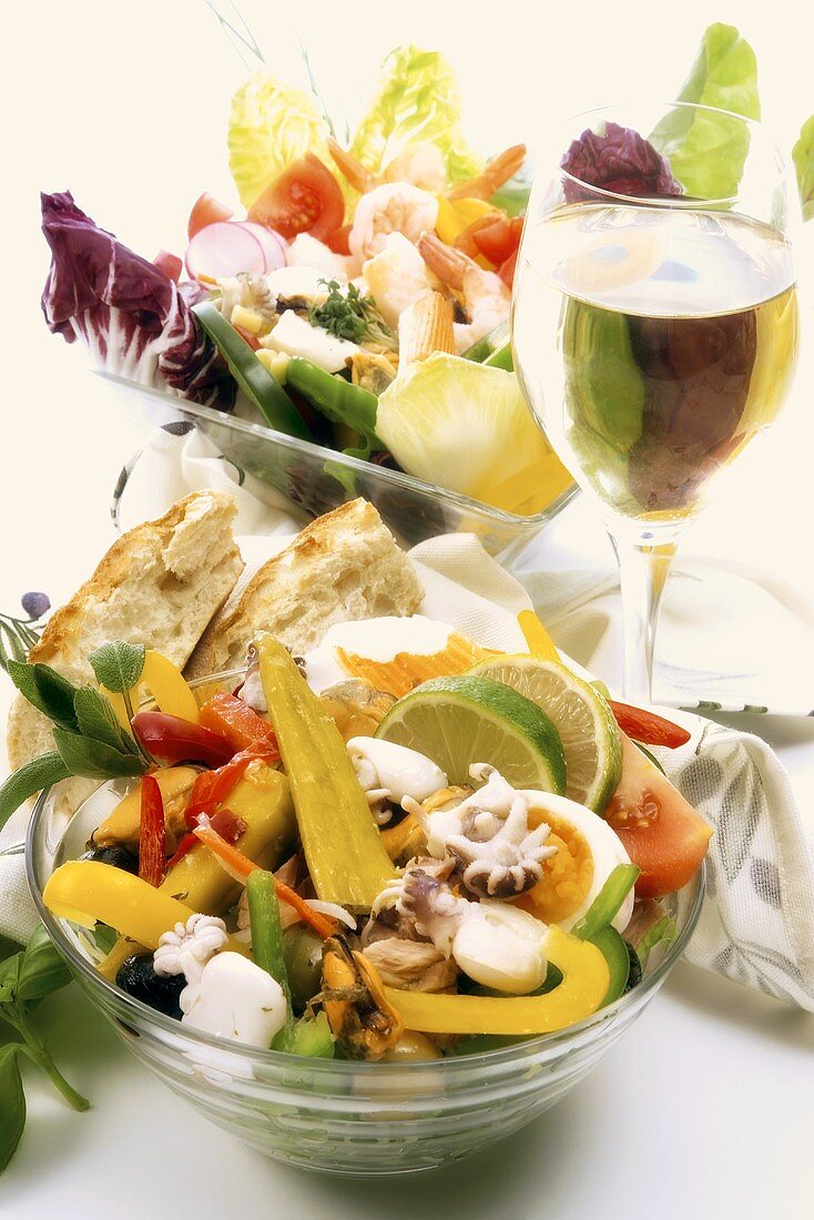 Seafood and vegetable salad with a glass of white wine