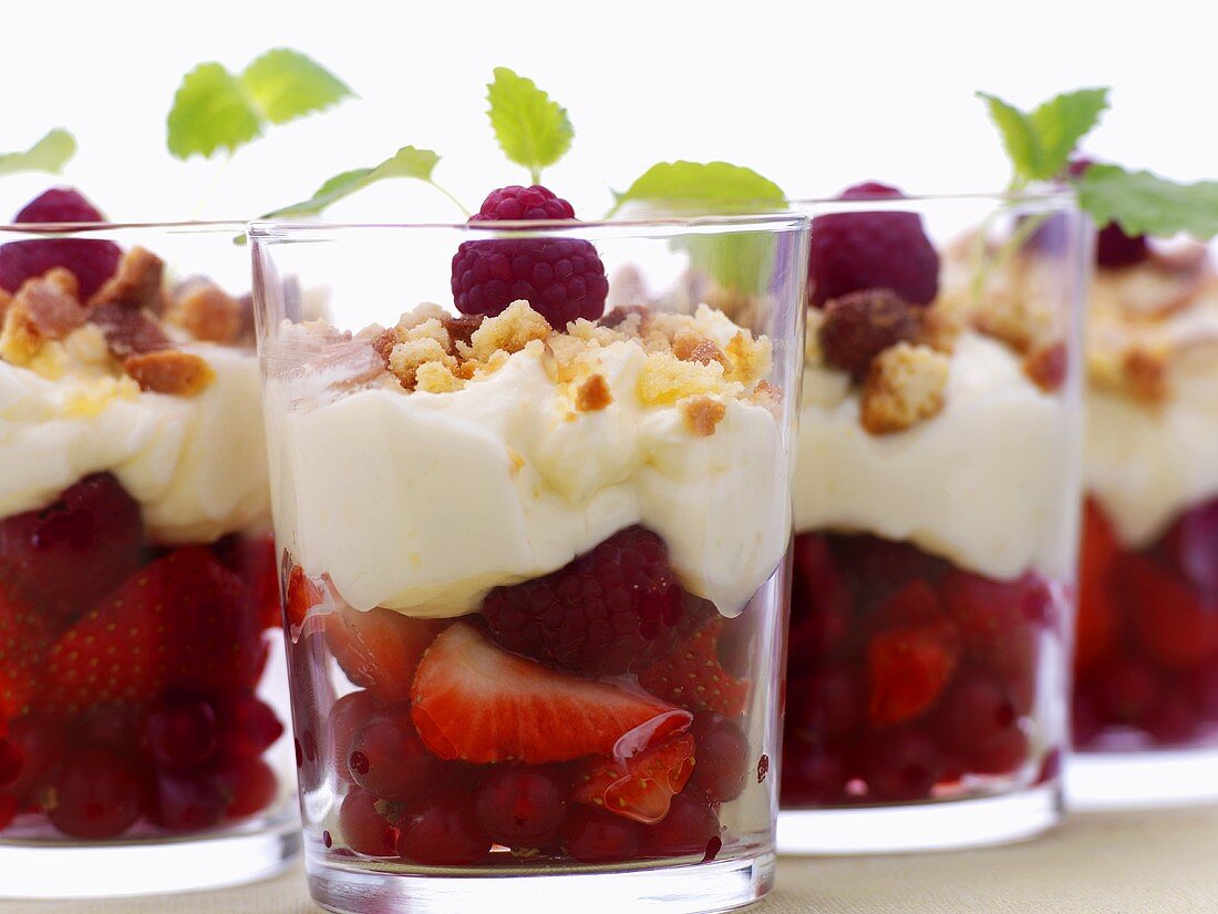 Berries with soft cheese topping in glasses