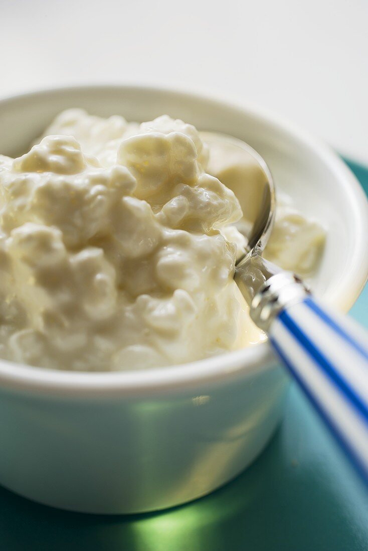 Cottage cheese in a small bowl with spoon