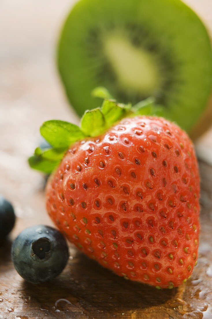 Strawberry, blueberries and half a kiwi fruit