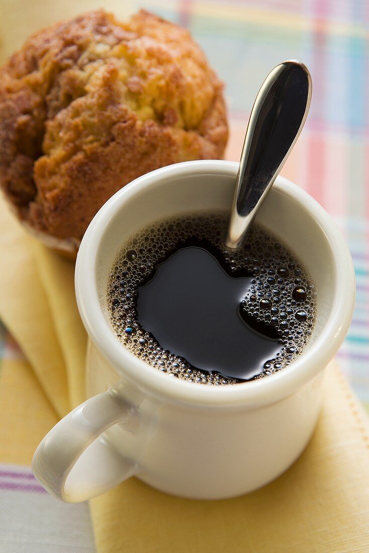 A mug of coffee and a muffin