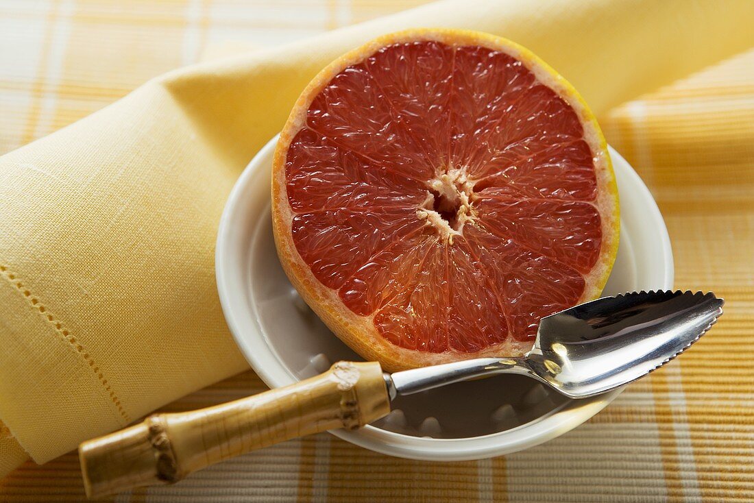 Grapefruit half with grapefruit spoon in a bowl
