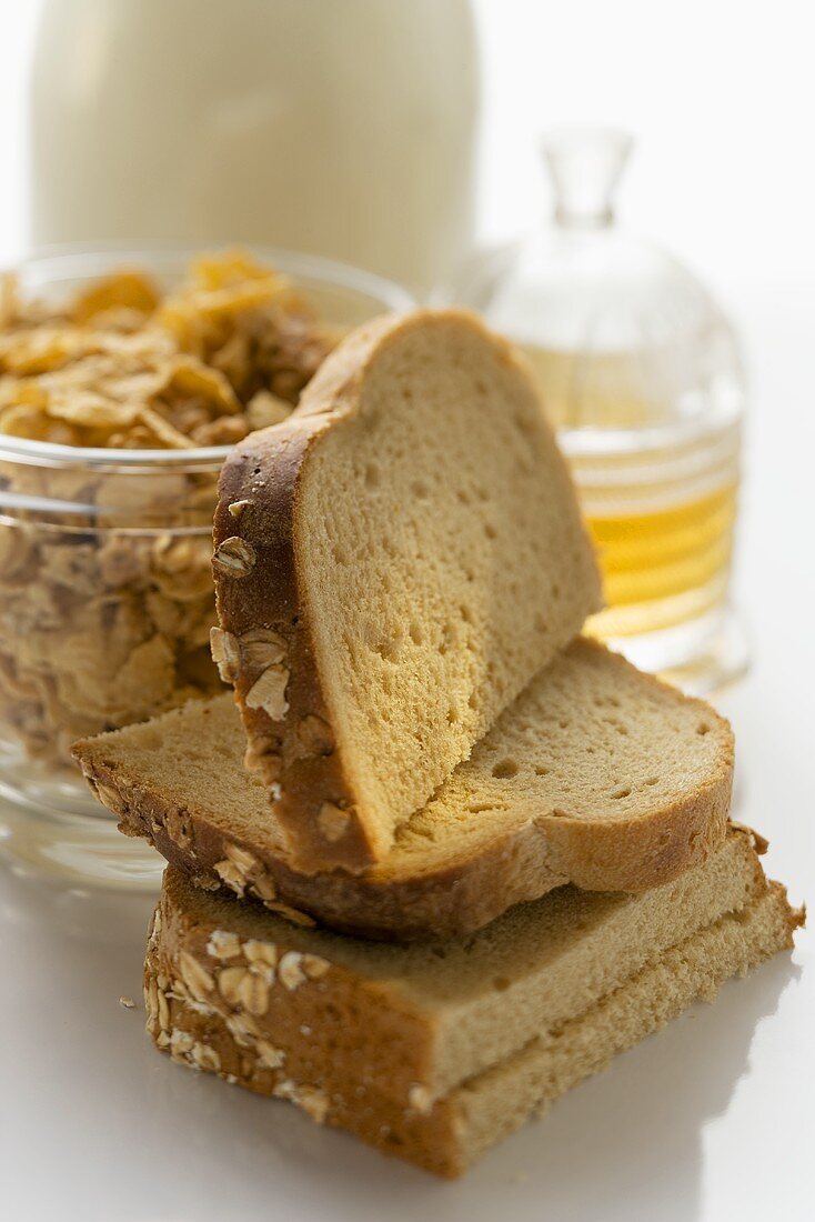 Slices of bread, cereal and honey