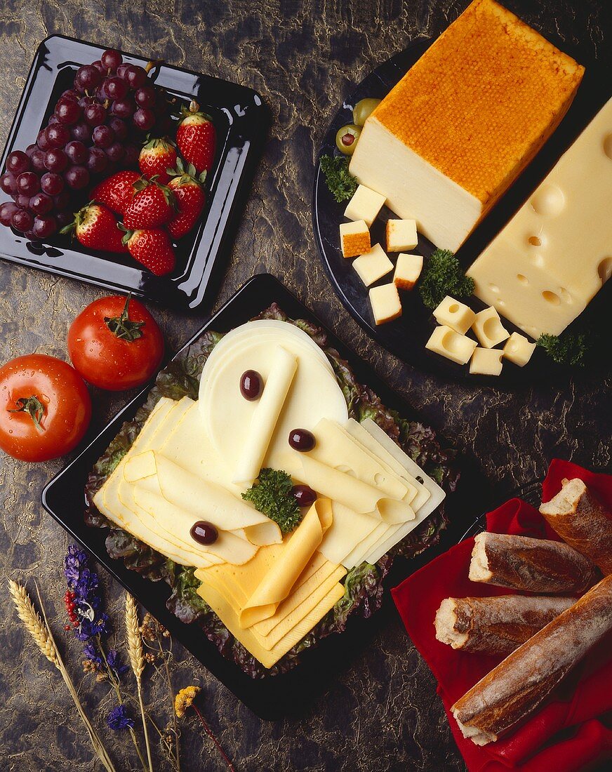 Assorted Cheese Slices on a Plate; Bread, Fruit and Cheese Blocks