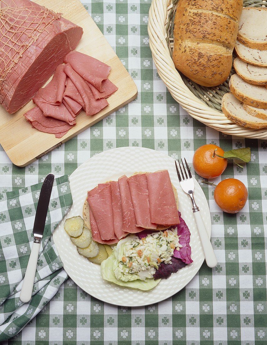 Sliced Corned Beef on a Plate with Cole Slaw on Shamrock Tablecloth
