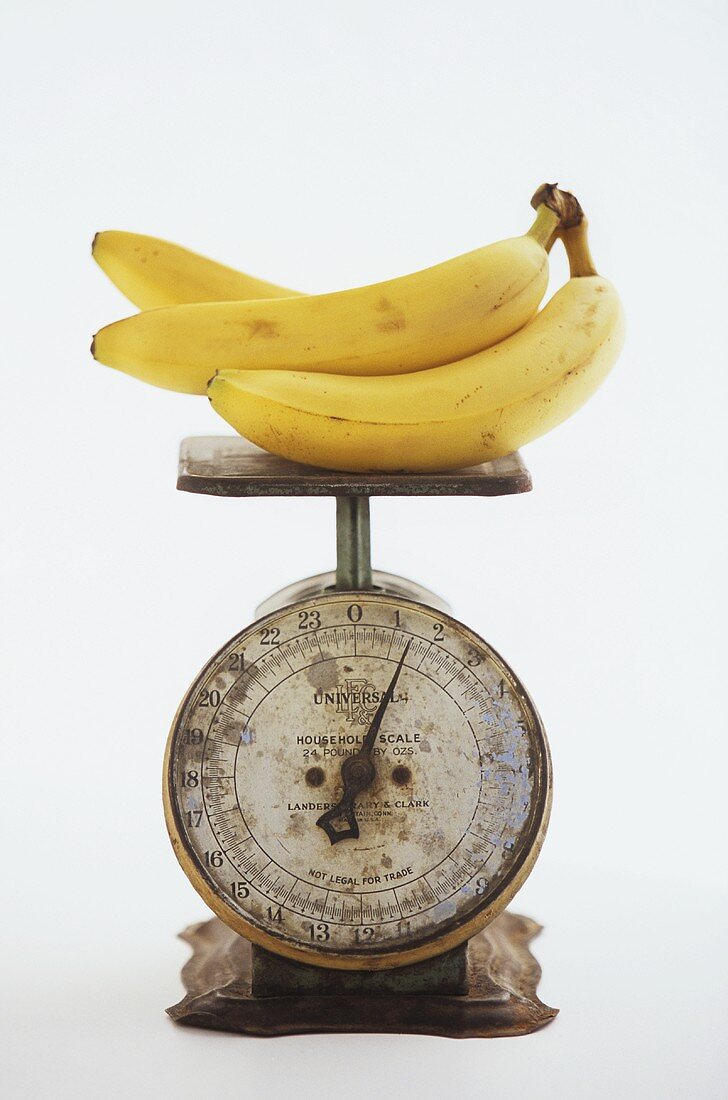 Bananas on an Old Metal Scale; White Background