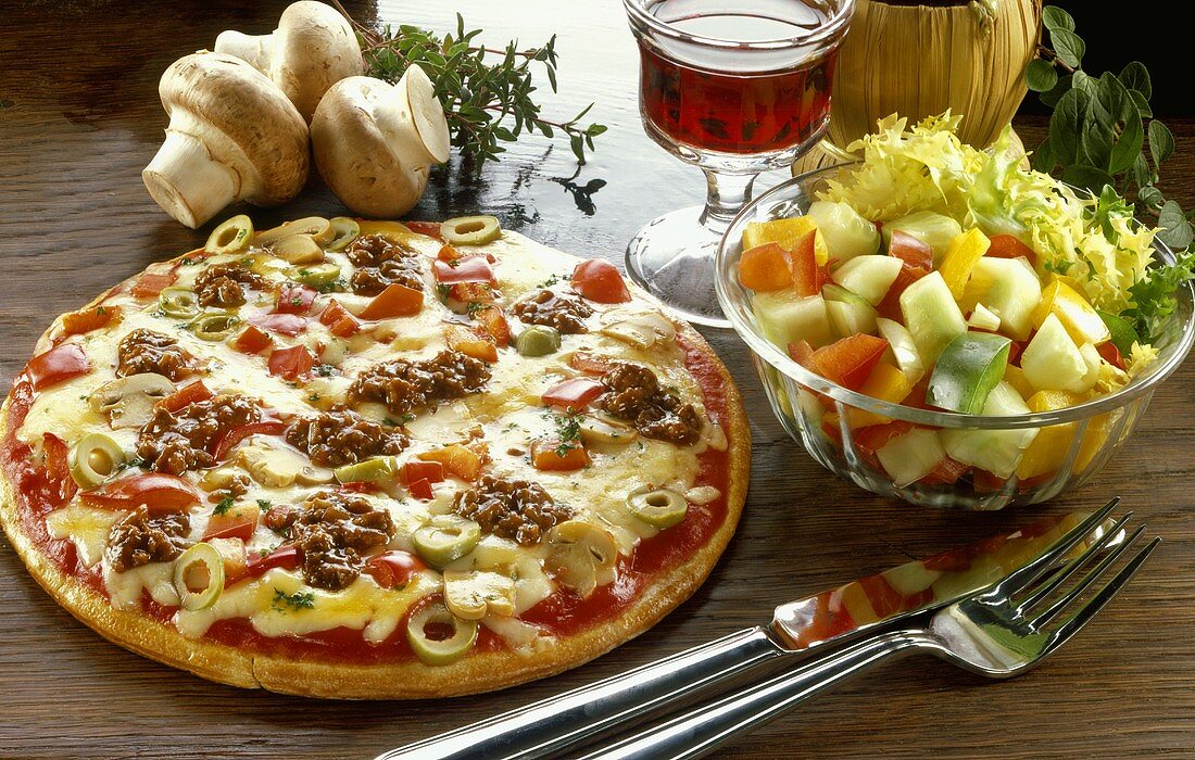 Pizza mit Gemüse, Oliven und Hackfleisch