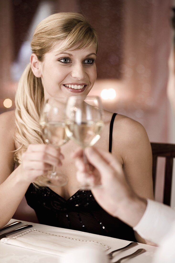 Young woman holding up wine glass