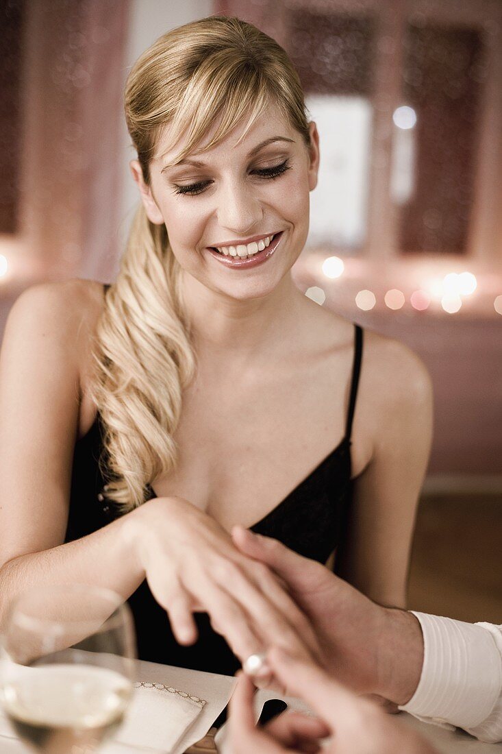 Young woman having a ring put on her finger