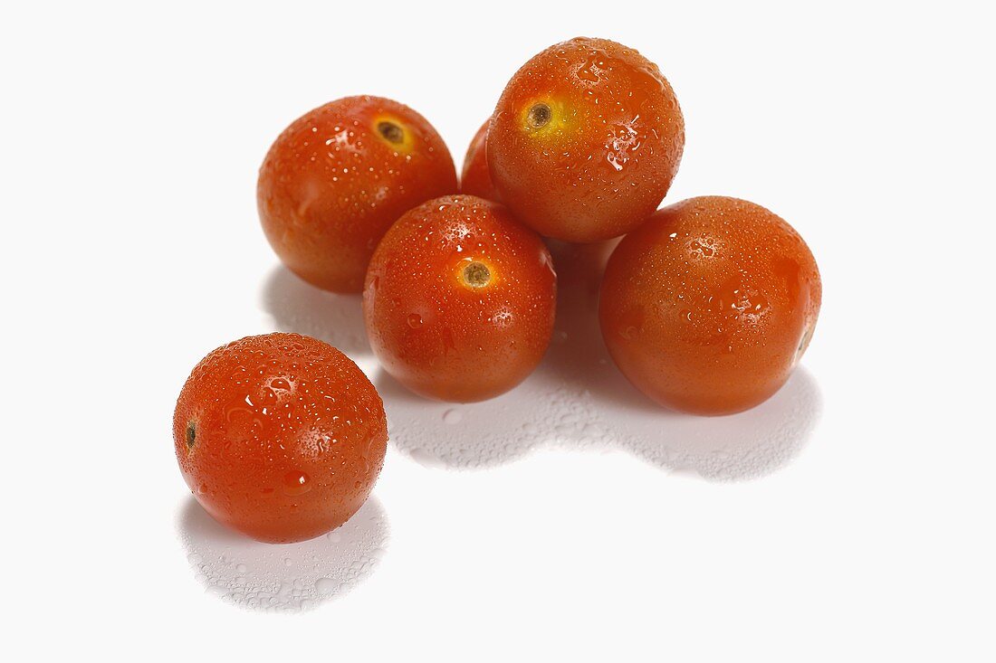 Six cherry tomatoes on white background