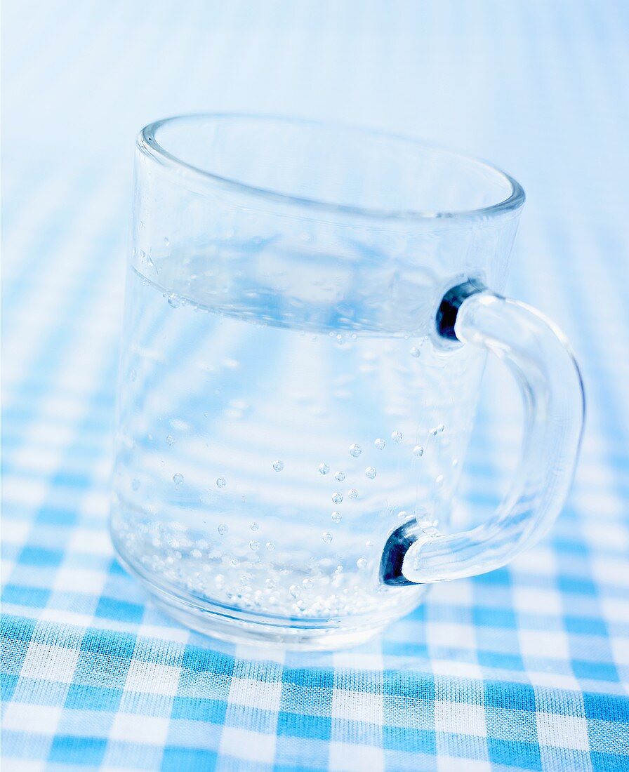 A glass mug of mineral water