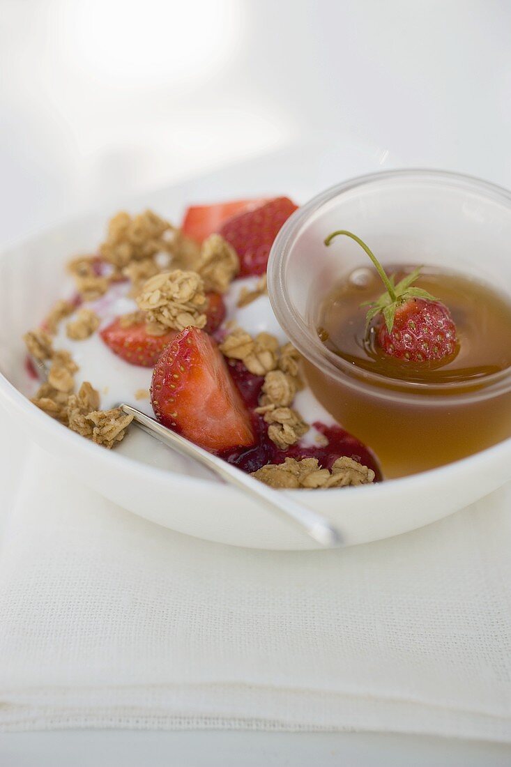 Yoghurt with muesli, fresh strawberries and honey