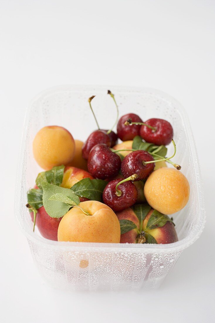 Nectarines, apricots and cherries in plastic punnet