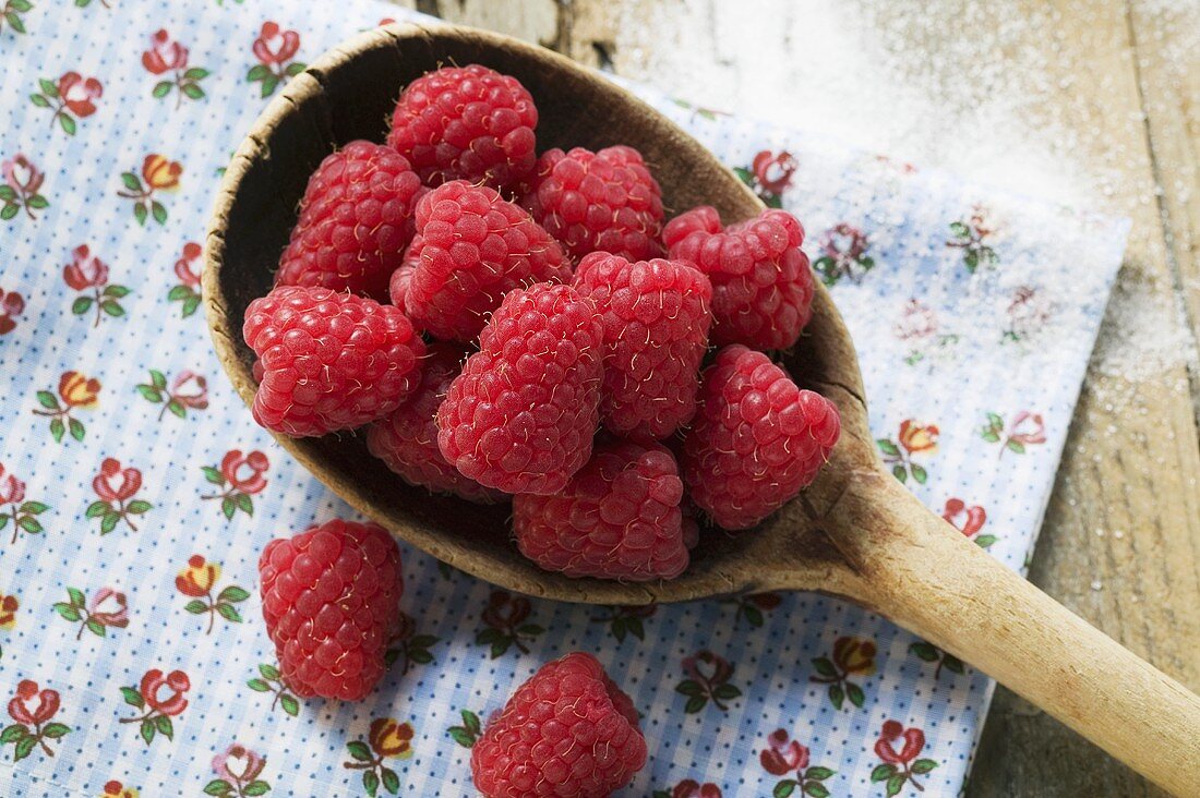 Fresh raspberries on a wooden spoon