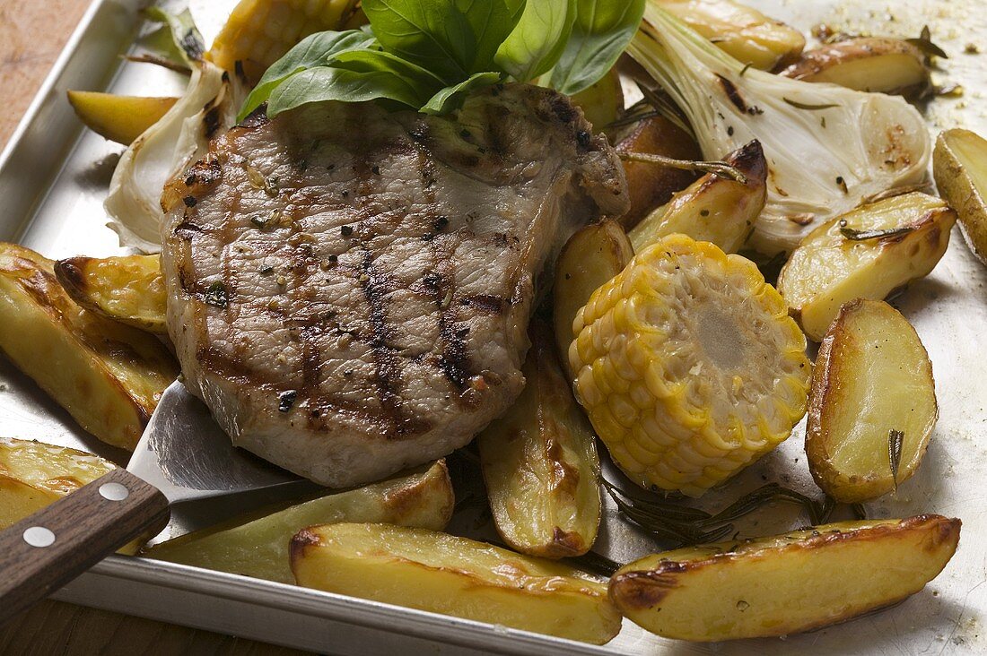 Grilled pork chop on roasted vegetables