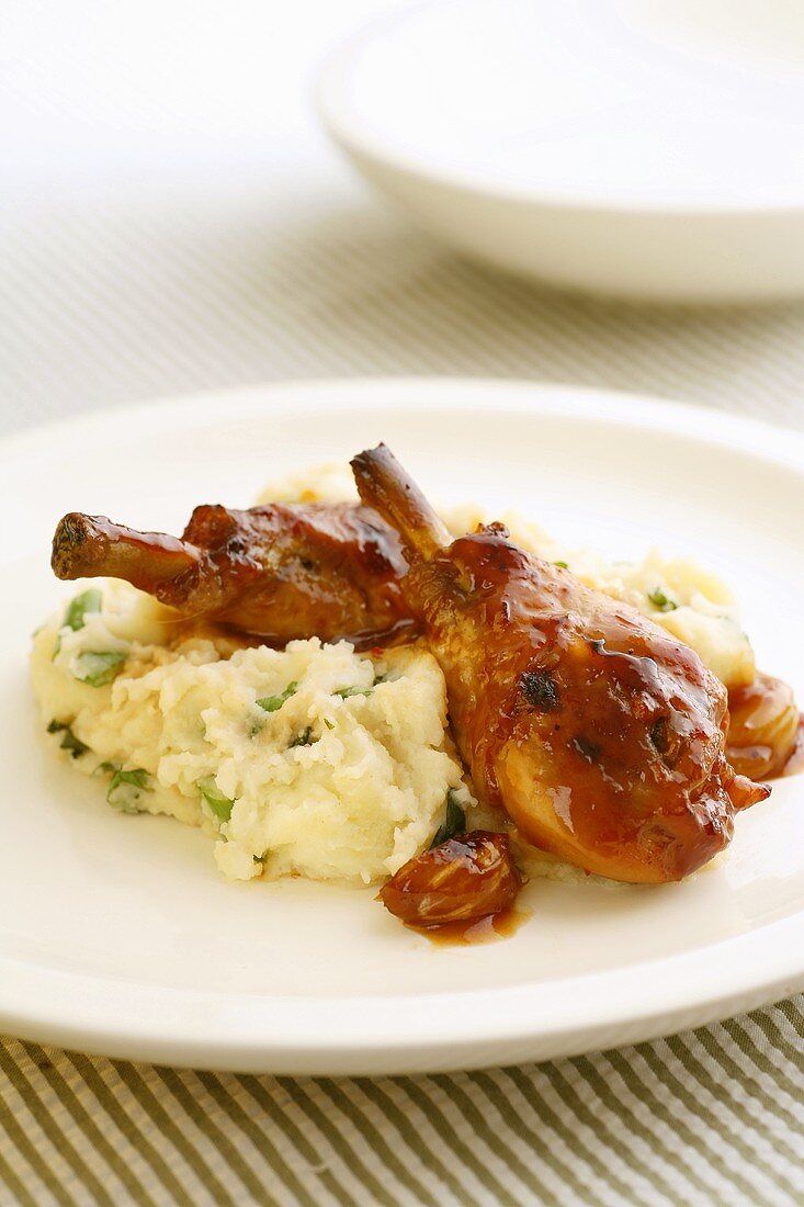 Glazed chicken legs on mashed potato