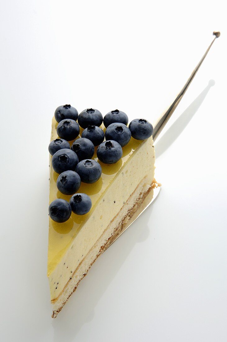 A piece of lemon cream cake with blueberries