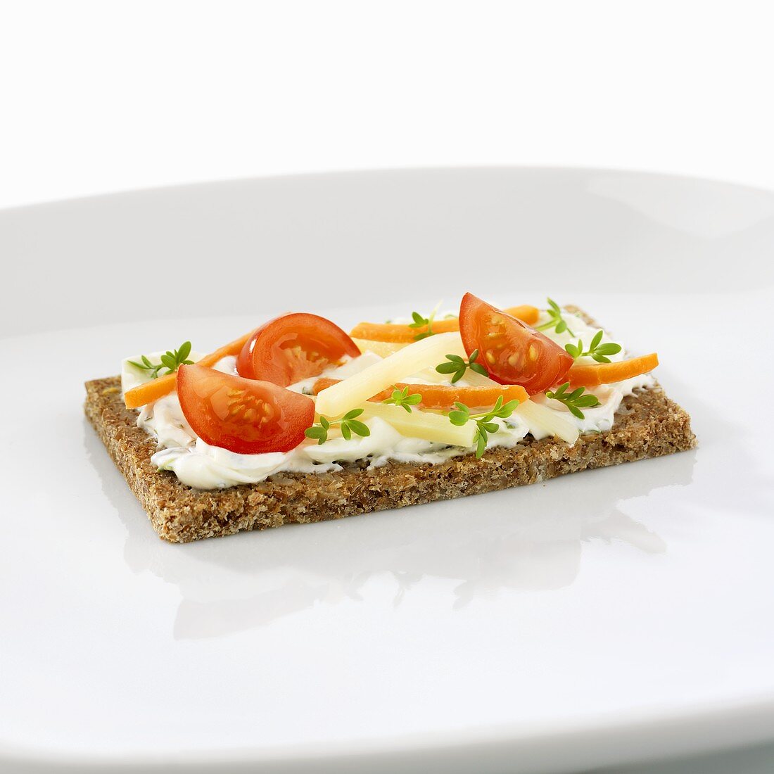 Quark with herbs and vegetable sticks on wholegrain bread