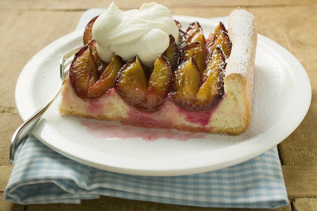 A piece of damson cake (Zwetschgendatschi) with cream