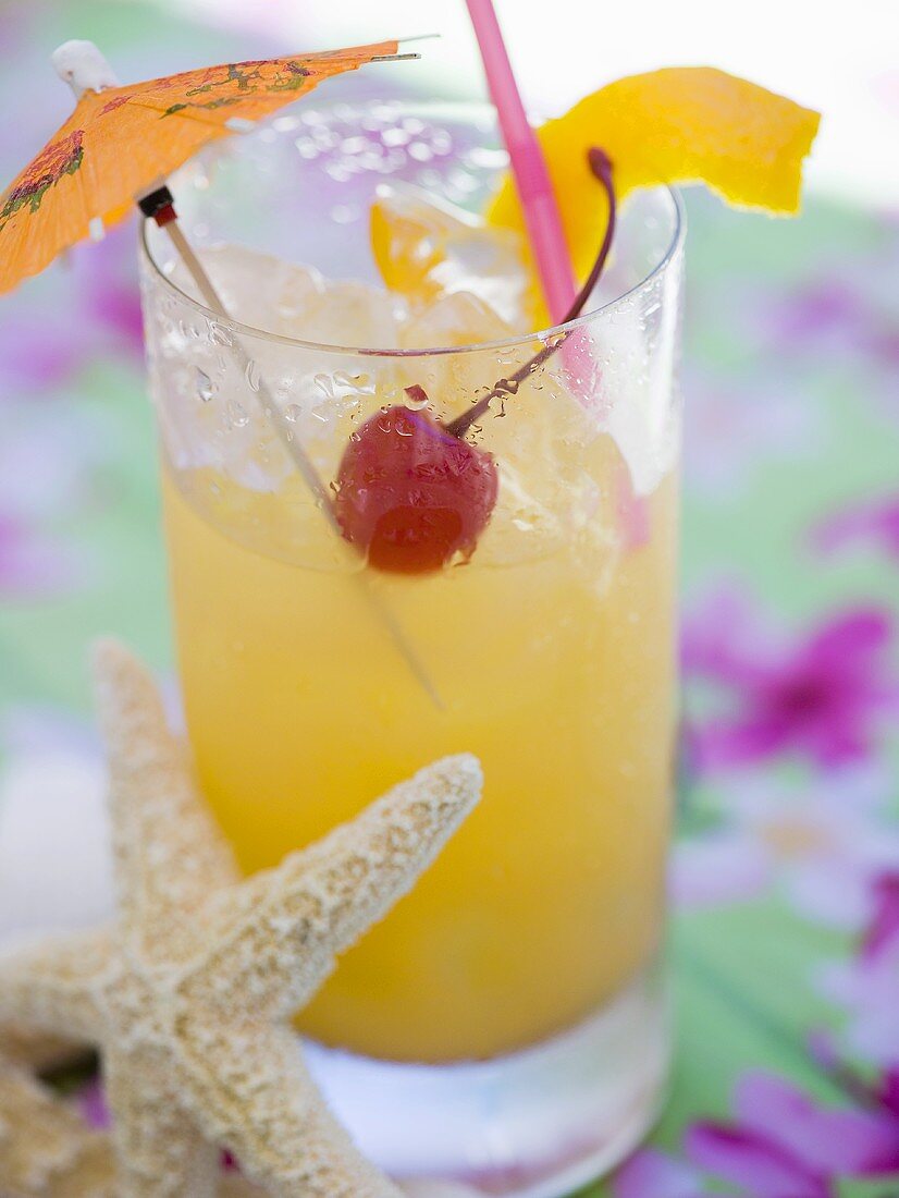 Fruit cocktail with cherry and lemon peel